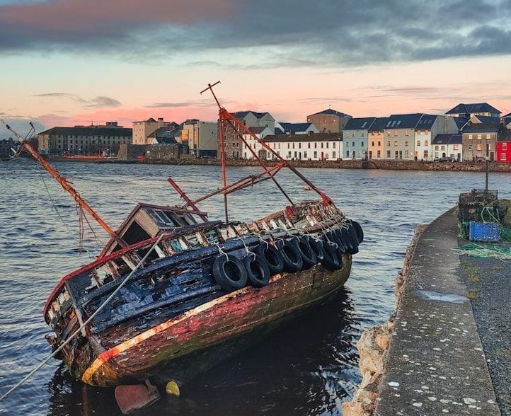 brown boat on dock during sunset