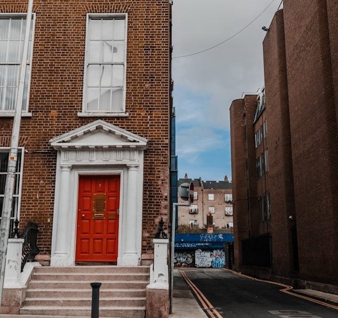 a brick building with a red door