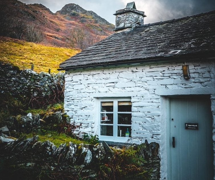 white wooden house on hill