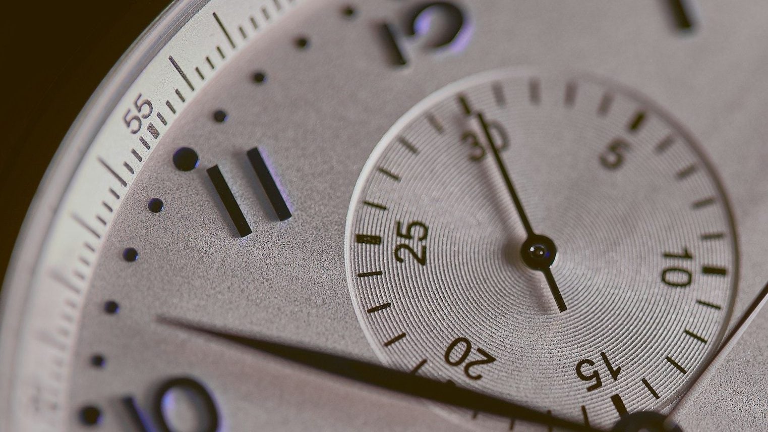 a close up of a silver watch face